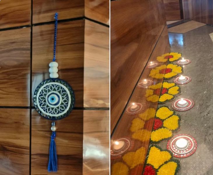 Customer photos of a Lippan evil eye hanging on a wooden wall and Lippan tealight holders lit beside a flower rangoli