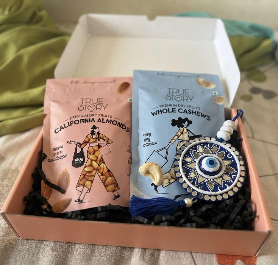 Nazar Raksha Gift Box — Evil Eye Hanging with Dry Fruits — handmade 6-inch lippan evil eye hanging with 100g california almonds & 100g whole cashews in gift box by Rachna Saxena